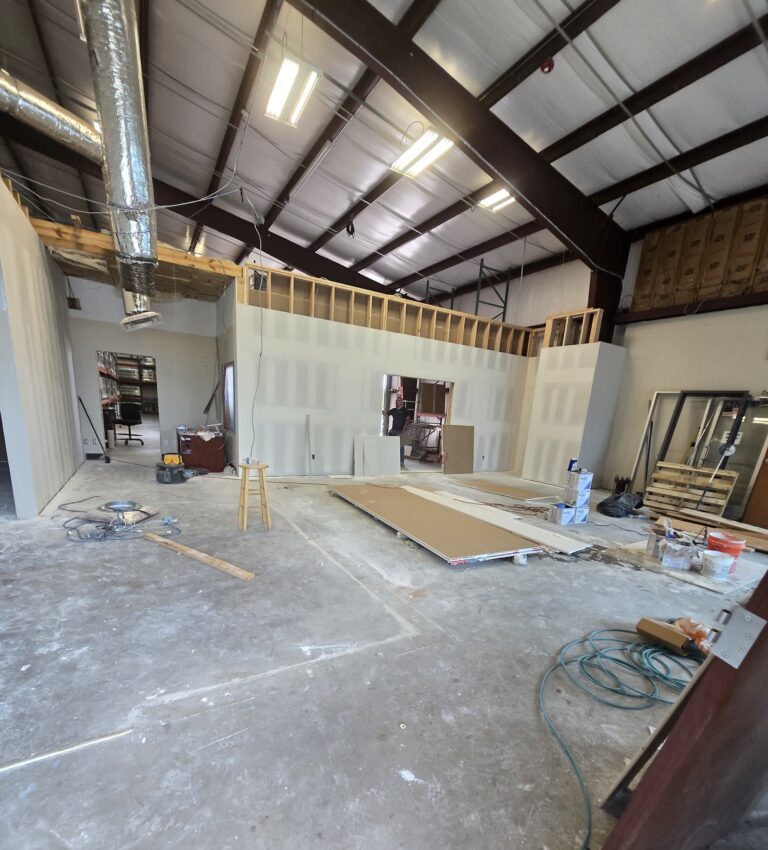 Commercial build-out in progress with metal stud framing and drywall, Long View Construction Services