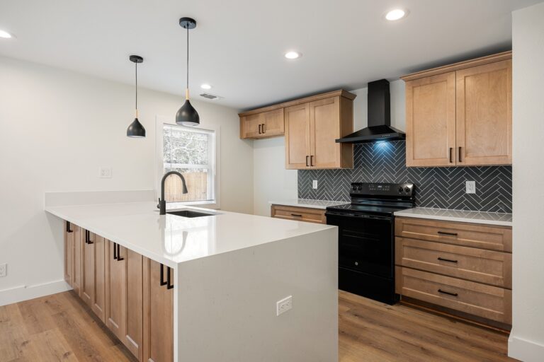 Kitchen remodel with quartz island and pendant lights